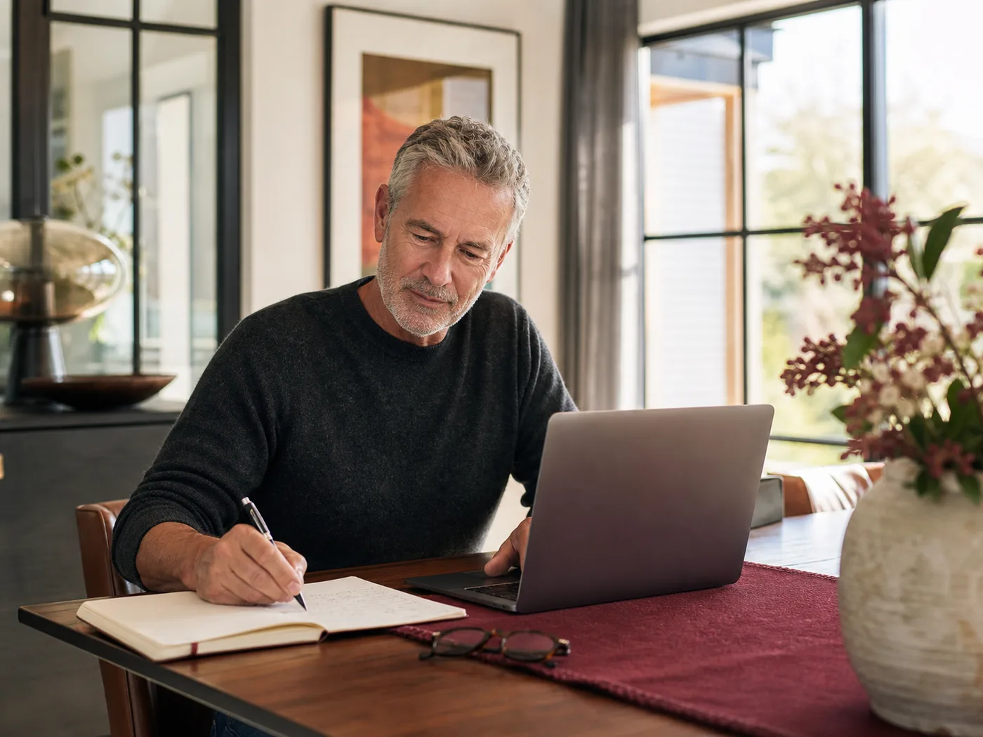 A man over 50 using a laptop to explore online dating